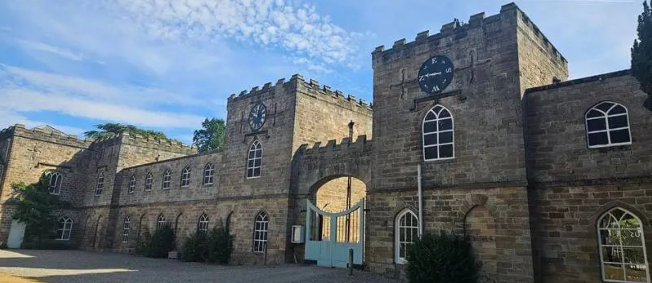 Stone courtyard and clock towers at Ripley Castle Estate